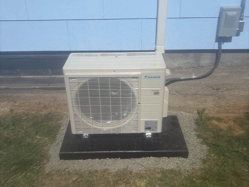 Daikin Outdoor Heat Pump Daikin outdoor heat pump installed on a composite mounting pad by Dave’s Heating.
